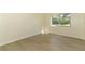 Bedroom features light wood flooring and a large window with lush green outdoor views at 662 Kenwick Cir # 102, Casselberry, FL 32707