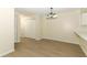 Bright dining room featuring light floors, closet, white walls and modern chandelier at 662 Kenwick Cir # 102, Casselberry, FL 32707