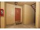Hallway view featuring a fire extinguisher, unit door, and stairs at 662 Kenwick Cir # 102, Casselberry, FL 32707