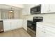 Modern kitchen with stainless steel appliances, quartz countertops, and sleek white cabinetry at 662 Kenwick Cir # 102, Casselberry, FL 32707