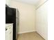 Efficient kitchen area with stainless steel refrigerator, cabinetry, and door to the hallway at 662 Kenwick Cir # 102, Casselberry, FL 32707
