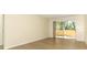 Spacious living room featuring wood floors and a sliding glass door to the covered patio at 662 Kenwick Cir # 102, Casselberry, FL 32707