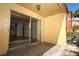 Sunny outdoor patio featuring textured walls and a sliding glass door at 662 Kenwick Cir # 102, Casselberry, FL 32707
