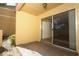 Sunny outdoor patio featuring textured walls and a sliding glass door at 662 Kenwick Cir # 102, Casselberry, FL 32707