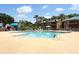 Community pool with sun loungers and shady canopy providing a resort-style living experience at 662 Kenwick Cir # 102, Casselberry, FL 32707