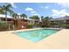 A sparkling community pool with lounge chairs and shade canopies at 662 Kenwick Cir # 102, Casselberry, FL 32707