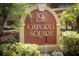 Community signage amongst lush landscaping and tropical palm trees at 662 Kenwick Cir # 102, Casselberry, FL 32707