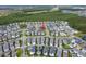 Aerial view of the home and surrounding neighborhood with mature trees and a pond at 6875 Bridgman St, Orlando, FL 32827