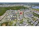 Aerial view of a residential neighborhood with a lake in the distance at 6875 Bridgman St, Orlando, FL 32827