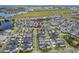 Aerial view of the community featuring homes, a lake, and green landscaping at 6875 Bridgman St, Orlando, FL 32827