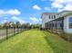 Expansive backyard with lush lawn, secure fencing, and a view of the home's exterior at 6875 Bridgman St, Orlando, FL 32827