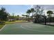 Outdoor basketball court framed by palm trees, landscaping, and clear skies with scattered clouds at 6875 Bridgman St, Orlando, FL 32827