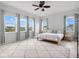 Bright bedroom with large windows, a ceiling fan, and a cozy rug creating a comfortable and inviting space at 6875 Bridgman St, Orlando, FL 32827