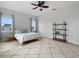 Inviting bedroom with a ceiling fan, a plush rug, and natural light streaming through the windows at 6875 Bridgman St, Orlando, FL 32827