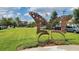 Outdoor butterfly art statue in a park-like setting with green space, trees, parked cars, and clear skies at 6875 Bridgman St, Orlando, FL 32827