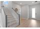 Welcoming entryway featuring hardwood floors, staircase, and neutral color palette with lots of natural light at 6875 Bridgman St, Orlando, FL 32827