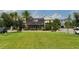 A commercial building with large windows overlooks a lush green lawn and is surrounded by trees at 6875 Bridgman St, Orlando, FL 32827