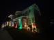 Festive home exterior with holiday decorations and lit reindeer on the front lawn at 6875 Bridgman St, Orlando, FL 32827