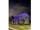 Front exterior view of a two-story home adorned with blue and orange holiday lights at 6875 Bridgman St, Orlando, FL 32827