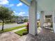 Charming front porch with a hanging chair, neutral columns, and brick flooring, perfect for relaxation at 6875 Bridgman St, Orlando, FL 32827