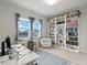 Bright home office space with large windows, modern desk, chair, and built-in shelving for ample storage at 6875 Bridgman St, Orlando, FL 32827
