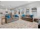 Open-concept living area with hardwood floors, modern lighting, and connecting to kitchen and outdoor views at 6875 Bridgman St, Orlando, FL 32827