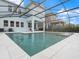 Screened pool with tiled deck is surrounded by an enclosure offering a great outdoor living space at 6875 Bridgman St, Orlando, FL 32827