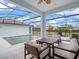 Inviting screened pool area with comfortable outdoor seating, perfect for relaxation and entertaining at 6875 Bridgman St, Orlando, FL 32827