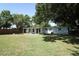 Spacious backyard with lush lawn and mature trees, perfect for outdoor activities and relaxation at 707 N Solandra Dr, Orlando, FL 32807