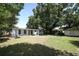 Large backyard with a lawn, a covered patio and an outbuilding at 707 N Solandra Dr, Orlando, FL 32807
