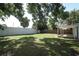 Spacious backyard with a fire pit and privacy fencing, ideal for entertaining at 707 N Solandra Dr, Orlando, FL 32807
