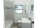 Bathroom showcasing a modern vanity, mirror, toilet, and tub at 707 N Solandra Dr, Orlando, FL 32807