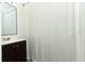 Bathroom showcasing a modern vanity, mirror, and a shower with a stylish curtain at 707 N Solandra Dr, Orlando, FL 32807