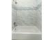 Modern bathroom featuring a tub with elegant tile surround and stylish fixtures at 707 N Solandra Dr, Orlando, FL 32807