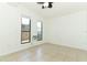 Bedroom featuring two windows, tiled floors, and a wall-mounted AC unit at 707 N Solandra Dr, Orlando, FL 32807
