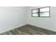 Bright bedroom showcasing wood-look floors and a window at 707 N Solandra Dr, Orlando, FL 32807