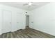 Bedroom with modern flooring, ceiling fan, and closet storage at 707 N Solandra Dr, Orlando, FL 32807