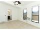 Bright bedroom with tile flooring, ceiling fan, and windows offering natural light at 707 N Solandra Dr, Orlando, FL 32807