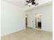 Bedroom featuring neutral walls, tile flooring, and a view into an en-suite bathroom at 707 N Solandra Dr, Orlando, FL 32807