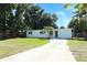 Charming single-story home with a well-maintained lawn, complemented by mature trees and an inviting driveway at 707 N Solandra Dr, Orlando, FL 32807
