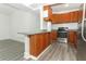 Updated kitchen with stainless steel oven and granite countertops, highlighted by gray floors and ample storage space at 707 N Solandra Dr, Orlando, FL 32807