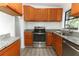 Kitchen features granite countertops, stainless steel appliances, and ample cabinet space for modern convenience and style at 707 N Solandra Dr, Orlando, FL 32807