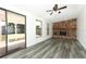 Spacious living room featuring a stone fireplace, sliding doors to a patio, and sleek floors at 707 N Solandra Dr, Orlando, FL 32807