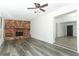 Bright living room featuring a unique stone fireplace and light grey wood-look floors at 707 N Solandra Dr, Orlando, FL 32807