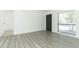 Bright living room offering sleek vinyl floors, white walls, and new doors leading to other rooms in the home at 707 N Solandra Dr, Orlando, FL 32807