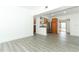 Open concept living space showcasing views into the kitchen with stainless appliances and granite counters, with gray flooring at 707 N Solandra Dr, Orlando, FL 32807