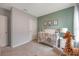 Charming Bedroom featuring a crib, decorative animal prints, and a cozy rocking chair for a soothing environment at 746 Mocking Jay Ln, St Cloud, FL 34771