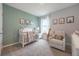 Charming Bedroom featuring a crib, decorative animal prints, and a cozy rocking chair for a soothing environment at 746 Mocking Jay Ln, St Cloud, FL 34771