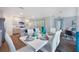 Open floorplan including the dining area and kitchen, with bar stool seating, stainless appliances, and natural light at 746 Mocking Jay Ln, St Cloud, FL 34771