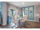Dining area with white table and chairs, mirrors, and sliding glass doors to the backyard at 746 Mocking Jay Ln, St Cloud, FL 34771